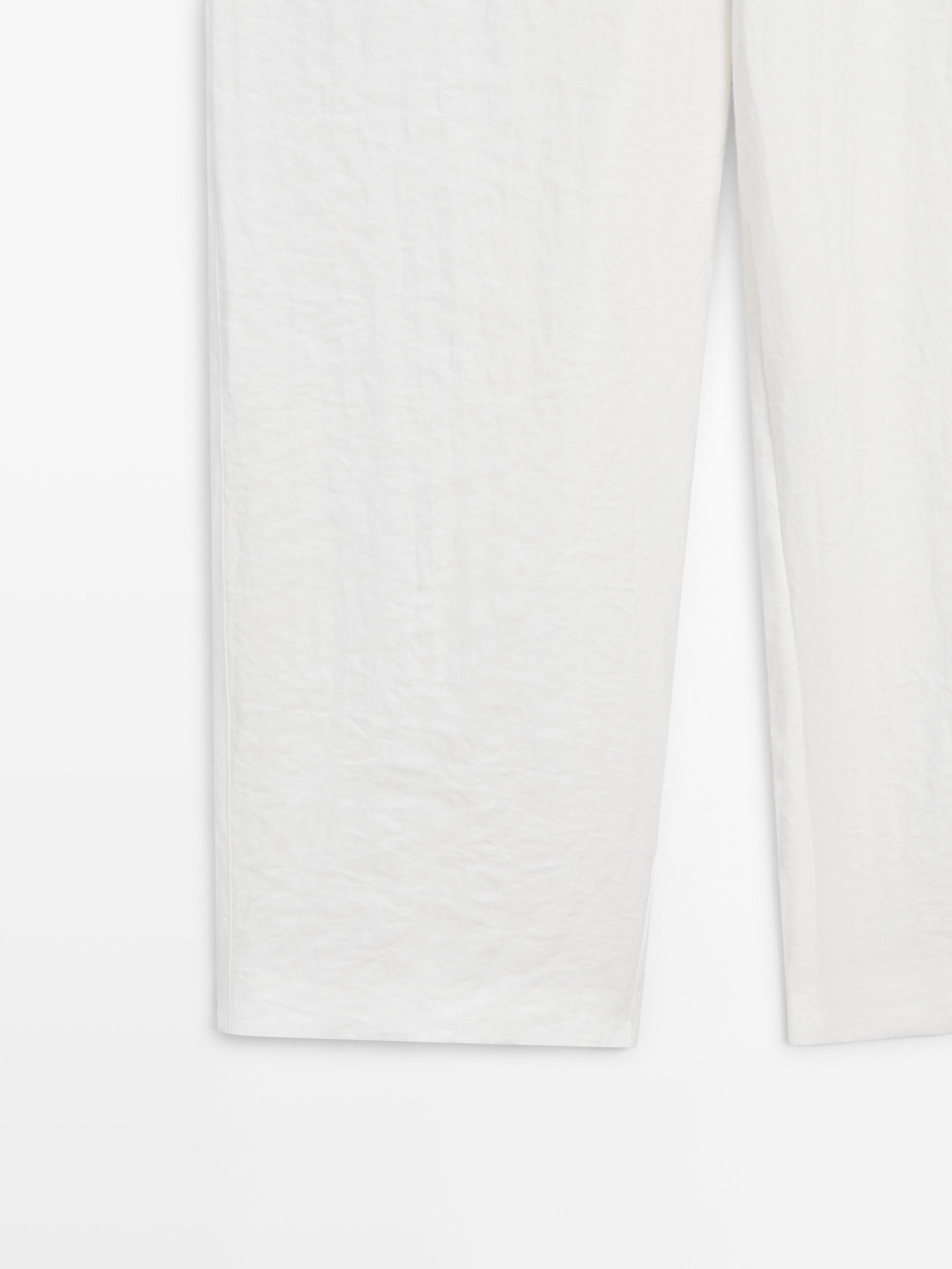Flowing trousers with buckles